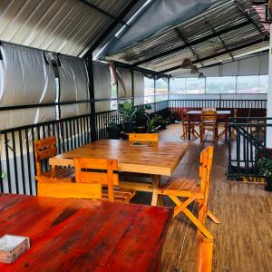 a dining room with wooden tables and chairs at Green View Peak in Gampola