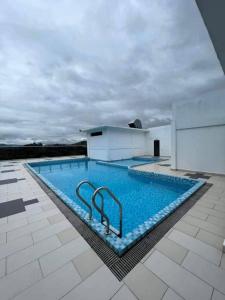 a large swimming pool on top of a building at ADEEN'S SURIA SUITE, Hotel Mutiara Gua Musang in Gua Musang