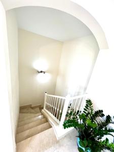 a staircase in a house with a plant at Elegant Palm Mar Apartment in Palm-Mar