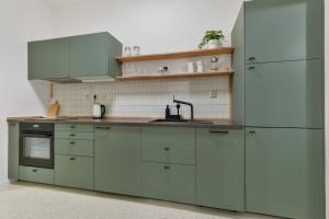 a kitchen with white cabinets and a sink at Charming Apt in Centre /w AC in Bratislava