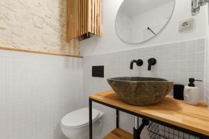 a bathroom with a sink and a toilet at Charming Apt in Centre /w AC in Bratislava