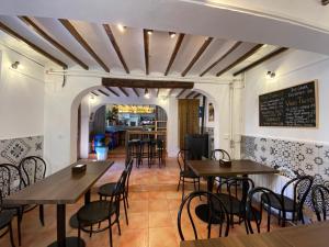 a restaurant with tables and chairs and a chalkboard at El Albergue Cirat in Cirat