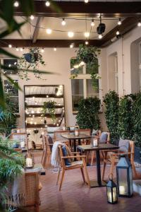 プラハにあるFalkensteiner Boutique Hotel Pragueのテーブルと椅子、植物のあるレストラン