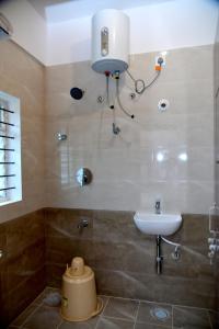 a bathroom with a sink and a toilet in it at Prince Recidency in Bangalore
