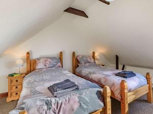 two twin beds in a room with a attic at 3 Bed in Brean MAINC in Berrow