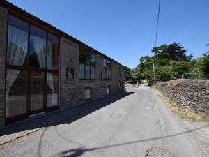 an empty road next to a brick building at 4 Bed in Whaley Bridge PK534 in Whaley Bridge