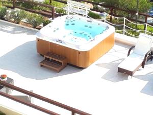 a jacuzzi tub on a patio with two chairs at Residence Maresol in Vieste
