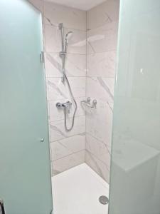 a bathroom with a shower with a glass door at Ferienwohnung St. Josef in Bodensdorf
