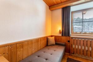 a bench in a room with a window at Schwüwong - Apartment 21 in Kelchsau