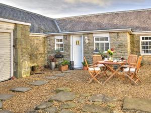 a patio with a table and chairs in front of a house at 2 Bed in Nr Gibside CN080 in Whickham