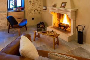 a living room with a couch and a fireplace at MALU' Exclusive Retreat in Pescocostanzo