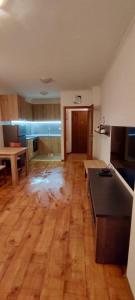 an empty kitchen and living room with a wooden floor at Apartment in Sapphire Residence in Bansko