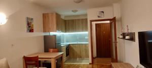 a small kitchen with a table and a dining room at Apartment in Sapphire Residence in Bansko