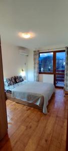 a bedroom with a large bed and a large window at Apartment in Sapphire Residence in Bansko