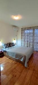 a bedroom with a large bed and a window at Apartment in Sapphire Residence in Bansko