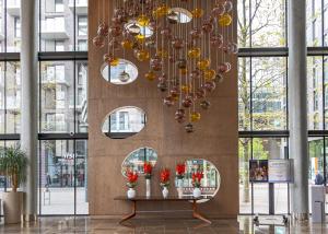 a chandelier in a building with a table with flowers at Hilton London Wembley in London