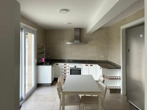 a kitchen with a table and chairs in a room at Apartagal-A Corredoira in Foz
