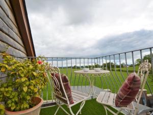 a balcony with a table and two chairs and a table at 1 Bed in Abergavenny 58309 in Abergavenny
