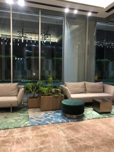 a lobby with a couch and a table in a building at Large Comfortable Bedroom in Alam Sutera Tangerang in Kampungklapa 2