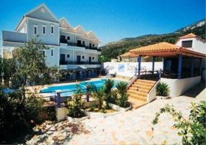 a large house with a swimming pool in front of it at Lygies Apart Hotel in Trapezaki