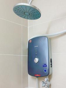 a soap dispenser on a wall in a bathroom at Ninja's Sweet Home in Kampong Gadong Jaya