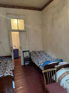 a room with two beds in it with a window at Sabir's Apartment Old Town in Tbilisi City