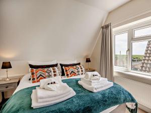 um quarto com toalhas numa cama com uma janela em 3 Bed in Brighton 64950 em Saltdean