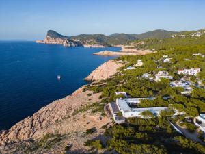 an aerial view of a resort on a rocky coast at Hostal La Torre Ibiza Cap Negret in San Antonio