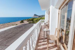 a balcony of a house with a view of the ocean at Hostal La Torre Ibiza Cap Negret in San Antonio
