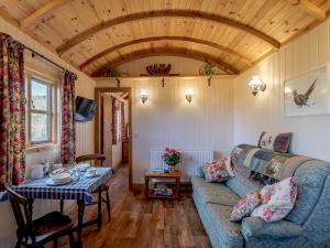 a living room with a blue couch and a table at 1 Bed in Ironbridge 77906 in Leighton