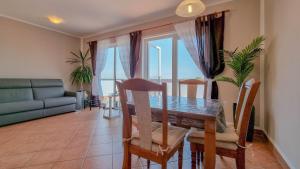 a dining room with a table and chairs and a couch at Crveni Vrh A4+2 in Crveni Vrh