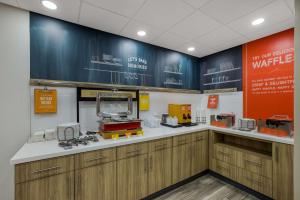 a waiting room with a counter with machines on it at Hampton Inn Linden in Linden