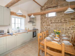a kitchen and dining room with a table and chairs at 4 Bed in North York Moors National Park 75301 in Rosedale Abbey