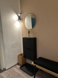 a room with a mirror and a bench and a table at Appartement Elena in Linz