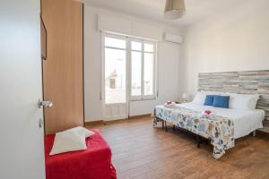a bedroom with a bed and a large window at CapoSud - Suite Fiocco in Marina di Ragusa +19 photos
