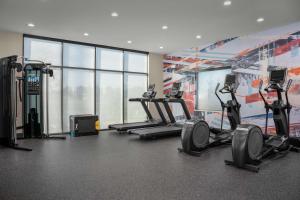 a gym with cardio machines and a large window at Home2 Suites By Hilton Cullman in Cullman