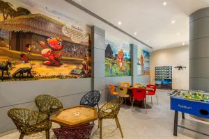 a childrens play room with tables and chairs at Sterling Puri in Puri
