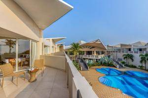 a balcony of a resort with a swimming pool at Sterling Puri in Puri