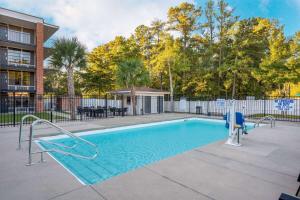 a swimming pool with a slide in a yard at Wyndham Garden Columbia-Ft Jackson in Columbia