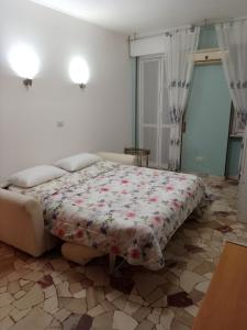 1 dormitorio con 1 cama con manta de flores en Cozy home baranzate, en Baranzate