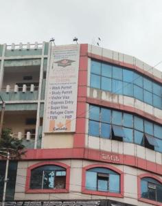 a building with a sign on the side of it at Spacious Flat - Centrally Located in Hyderabad