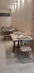a group of tables and chairs in a room at Pousada Xamã Tour in João Pessoa