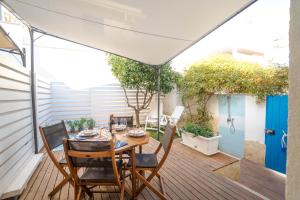 a patio with a table and chairs on a deck at CapoSud - Suite Randa in Marina di Ragusa