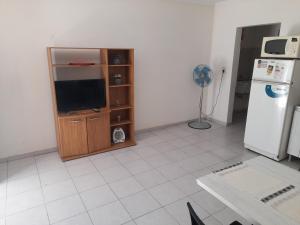 a living room with a television and a refrigerator at Departamentos del Sol in Resistencia