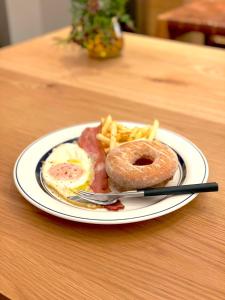 a plate of food with eggs and french fries on a table at CAFE/MINIMAL HOTEL OUR OUR in Tokyo