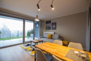a living room with a table and a couch at VacationClub – Bukowa 17A Apartament E.2 in Wisła