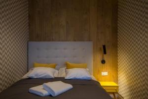 a large bed with two white pillows on it at VacationClub – Bukowa 17A Apartament E.2 in Wisła