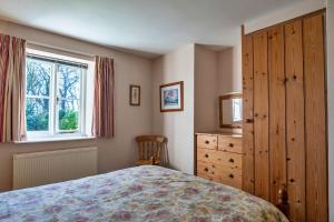 a bedroom with a bed and a dresser and a window at Finest Retreats - Swallows at St Keverne in Saint Keverne