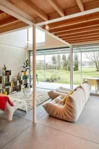 a living room with a couch and a large window at EvaMaria in Varsenare