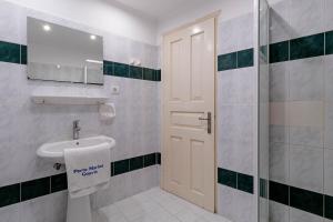 a bathroom with a toilet and a sink and a shower at Porto Marina Aparthotel in Gouvia +17 photos